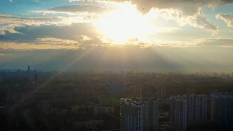 Aerial view of the city in the rays of the bright sun at sunset Stock Footage 145679810