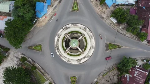 Aerial view of city square roundabout with traffic activity and dense settl.. Stock Footage 296463417