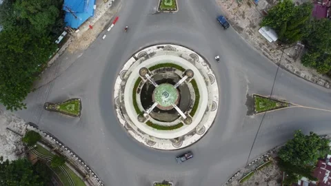 Aerial view of city square roundabout with traffic activity and dense settl.. Stock Footage 296463747