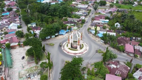 Aerial view of city square roundabout with traffic activity and dense settl.. Stock Footage 296463770