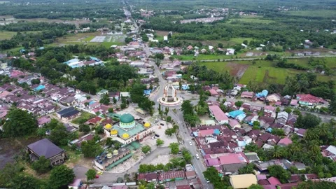 Aerial view of city square roundabout with traffic activity and dense settl.. Video stock 296464765