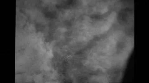 Aerial view of city through clouds during World war II Stock Footage