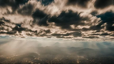 Aerial View of Cityscape with Dramatic Clouds and Mountain Ranges Stock Footage 284742289