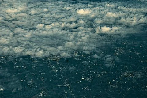 Aerial view of cityscape under clouds Stock Photos