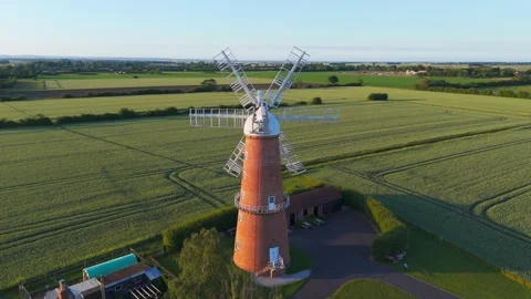 Aerial view of a classic windmill in a green field Vidéo 342611685