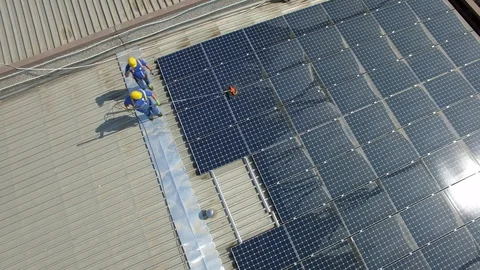 Aerial view of cleaning solar panels on the roof Stock Footage