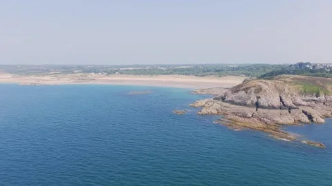 Aerial view of the clear blue waters and rugged rocky coastline of Anse du Croc Stock Footage 346676462