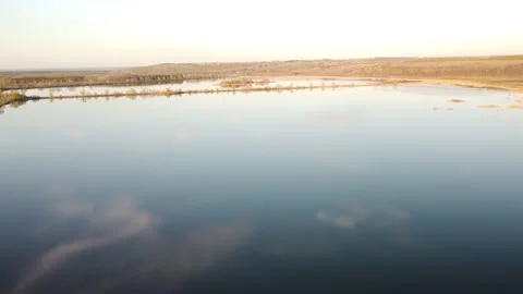 Aerial view clear bright day showing calm waters on the inland loch Stock Footage 201330921