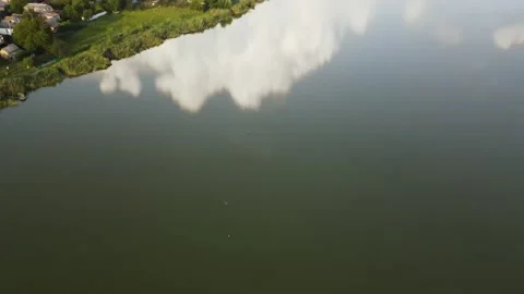 Aerial view of Clear Reflection Lake in Valley near to Hills, Village Stock Footage 162622173