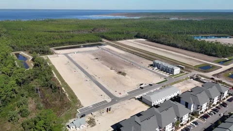 An Aerial View of Cleared Land Plots, Retention Ponds, and Residential Stock Footage 297689876