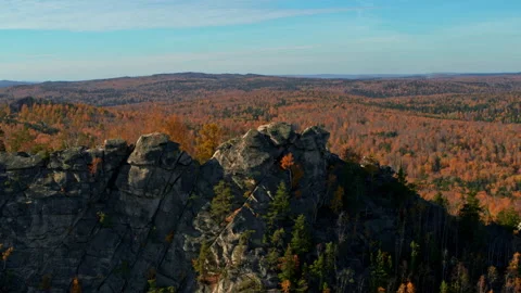 Aerial view of a cliff with an autumn forest Stock Footage 173402617
