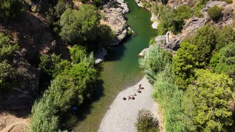 Aerial view of cliff jumpers in deep river pool, Benahavis, Spain Stock Footage 339638225