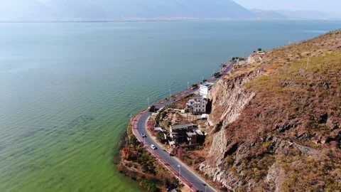 Aerial view of cliff lakeside road mountain lake magnificent scenery in Dali Stock Footage 337923182
