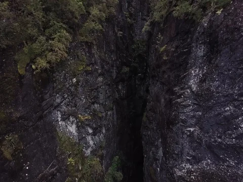 Aerial View of Cliff Mountain side with Dark Valley between. Trees and Forest 스톡 동영상 82981198