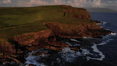 Aerial view of Cliffs along coastline at sunset with sunset sky Ireland. Video stock 243625341