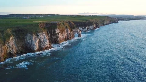 Aerial view of cliffs with arch during sunset in Northern Ireland Stock Footage 89871286
