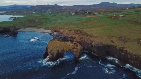 Aerial view of cliffs with arch in ocean in Fanad, Ireland Stock Footage 90084011