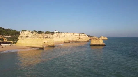 Aerial view of cliffs, arches and caves of the Marinha Beach Stock Footage 167783936
