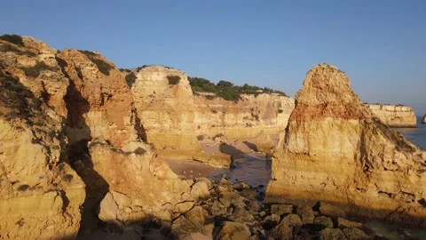 Aerial view of cliffs, arches and caves of the Marinha Beach Stock Footage 167784025