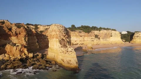 Aerial view of cliffs, arches and caves of the Marinha Beach Stock Footage 167784044