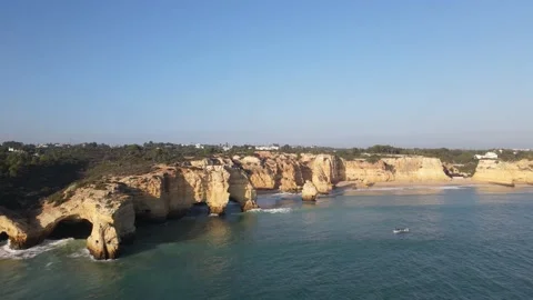 Aerial view of cliffs, arches and caves of the Marinha Beach Stock Footage 167784178