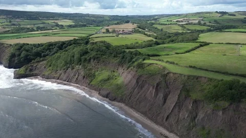 Aerial view of cliffs just south of Robin Hoods Bay, North Yorkshire, UK. Video stock 318929944