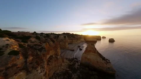 Aerial view of cliffside at dusk, ocean meets stone in peaceful harmony Video stock 346091304