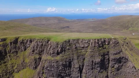 Aerial View of Cliffside Grassland Overlooking the Sea Stock-Footage 338320174
