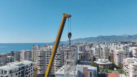 Aerial View: Climbing ladders with ease, the operator assembles crane parts Vídeo Stock 296021175