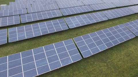 Aerial view  Close up flight over solar panels modules on green meadow Stock Footage 75466448