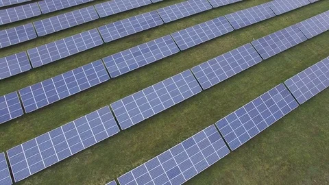 Aerial view  Close up flight over solar panels modules on green meadow Stock Footage 75466551