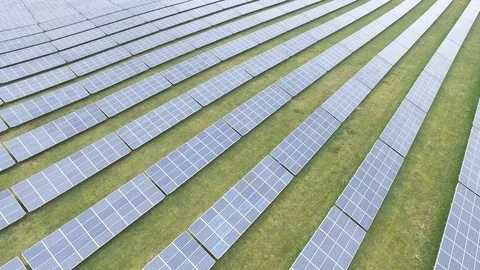 Aerial view  Close up flight over solar panels modules on green meadow Stock Footage 75466643