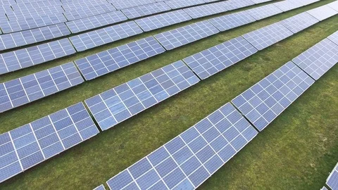 Aerial view  Close up flight over solar panels modules on green meadow Stock Footage 75466913