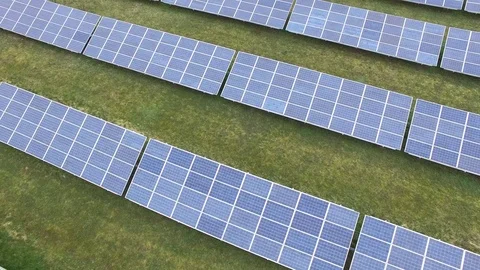 Aerial view  Close up flight over solar panels modules on green meadow Stock Footage 75467076