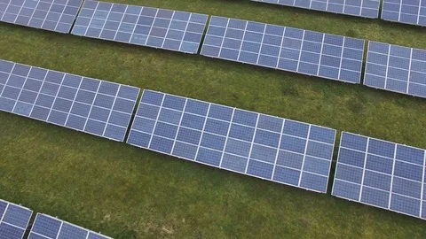 Aerial view  Close up flight over solar panels modules on green meadow Stock Footage 75467077