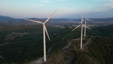 Aerial view close up of wind turbines and windmills from behind in a wind farm Stock Footage 339275566