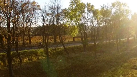 Aerial view close to young man in white helmet riding motorcycle at autumn Video stock 81246929