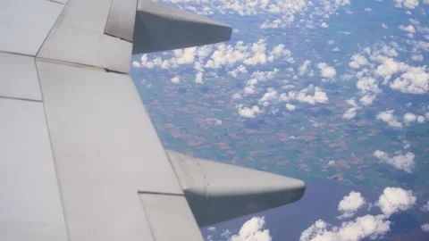Aerial View of Cloud Formations and Farmland Taken From Airplane Window During Stock Footage 303485506