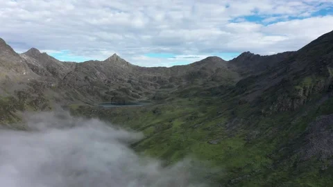 Aerial view of cloud sea rolling over mountainous landscape in Sichuan Plateau Видео 347693526