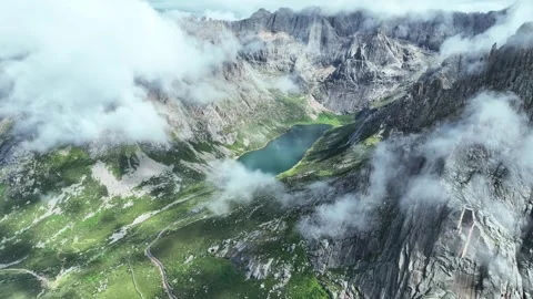 Aerial view of cloud winding high mountain valley flat lake peak forest in Aba Stock Footage 337926432