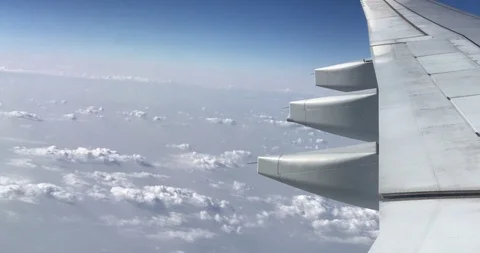 Aerial view of clouds, aircraft engine and wing through airplanes windows Stock Footage 113767232