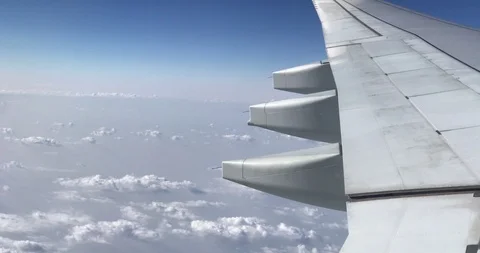 Aerial view of clouds, aircraft engine and wing through airplanes windows Video stock 113767267