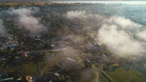 Aerial view of clouds and a barely visible village. Stock Footage 113379836