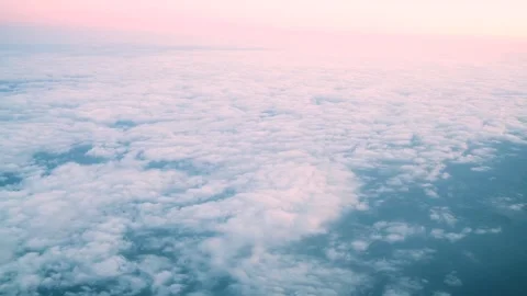 Aerial view of clouds and blue sky from the window of an aircraft Stock Footage 242336138