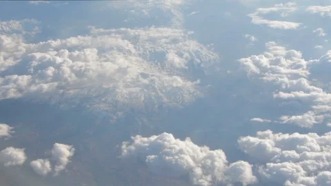 Aerial view of clouds and the Earth from the cockpit of an airplane, camera move Stock Footage 246144249