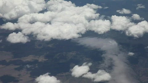 Aerial View of Clouds and Ground from Airplane Stock Footage 485675