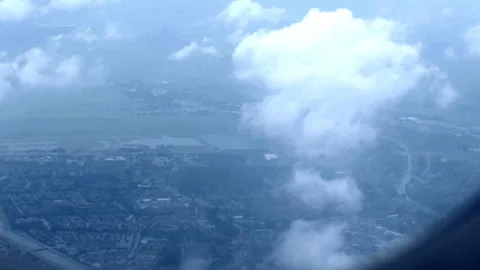 Aerial View of Clouds and Ground from Airplane Window Stock Footage 343978286