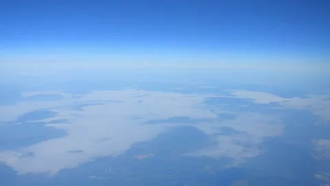 Aerial view of clouds and land from a high altitude Stock Footage 290094375