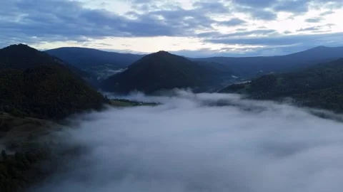 Aerial view clouds and mist moving carpathians mountains ,landscape with fog 動画素材 327594805