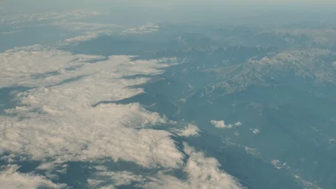 Aerial View Of Clouds And Mountains From An Airplane Stock Footage 125356881